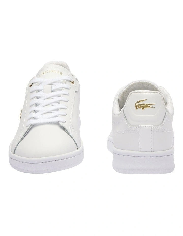 Lacoste Carnaby Pro Leather Sneakers in White/Gold, featuring a sleek leather upper with gold accents for a luxurious, stylish design.