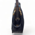 Black genuine leather tote bag with premium craftsmanship, minimalist design, and spacious interior from LeatherLuxe.