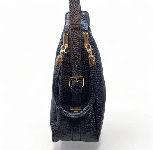 Black genuine leather tote bag with premium craftsmanship, minimalist design, and spacious interior from LeatherLuxe.