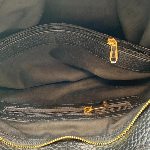 Black genuine leather tote bag with premium craftsmanship, minimalist design, and spacious interior from LeatherLuxe.