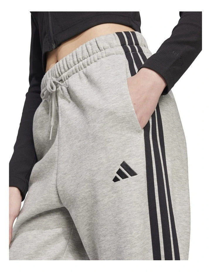 Adidas Essentials 3-Stripes Fleece Loose-Fit Joggers in Grey with soft fleece, loose fit, and iconic 3-Stripes design