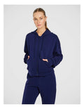 Rockwear Travel Zip Through Hoodie in Blue, featuring a relaxed fit, hip-length silhouette, and side pockets for a cozy, stylish look.