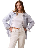 Calvin Klein Jeans white monogram baby tee with slim fit, cropped length, ribbed cotton stretch fabric, short sleeves and crew neck