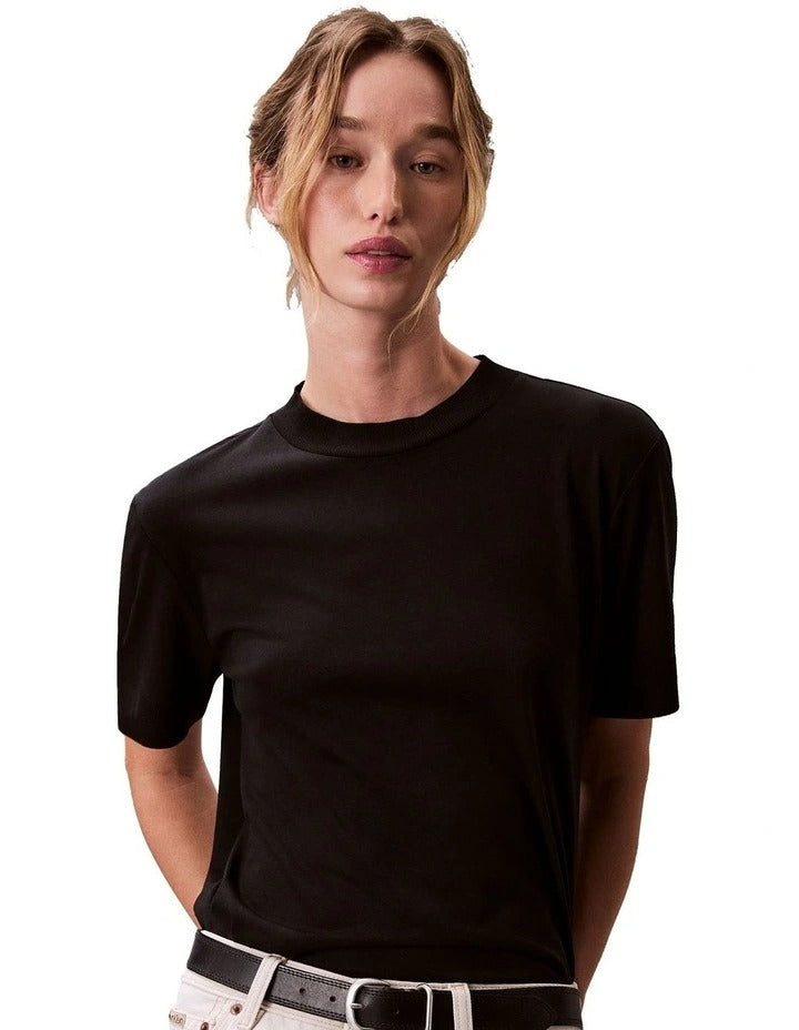 Calvin Klein women’s mock neck top in lyocell cotton blend with ribbed trims, classic fit, and signature logo.