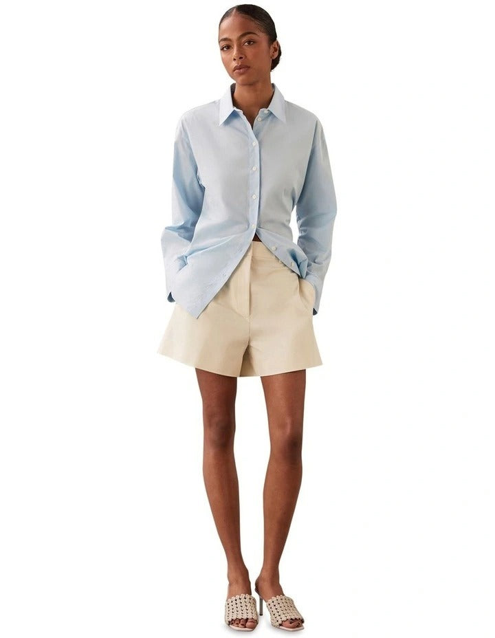 Calvin Klein women’s high rise cotton blend trousers with pressed creases, side seam pockets, and tailored fit