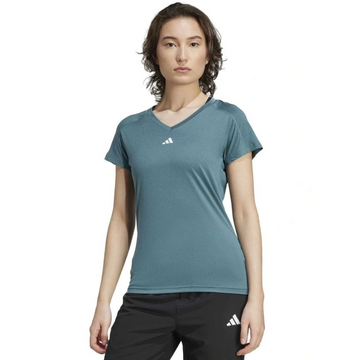 Person wearing a teal Adidas t-shirt and black shorts on a white background