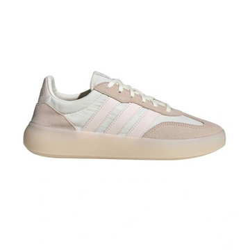 Beige and white sneaker with Adidas logo on a white background