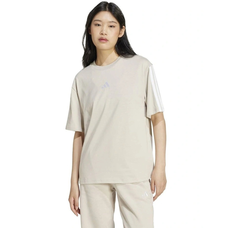 Person wearing a beige t-shirt and pants on a white background