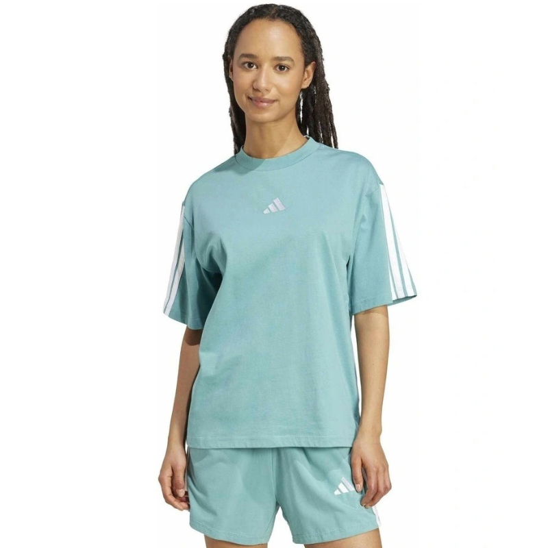 Person wearing a light blue Adidas outfit on a white background