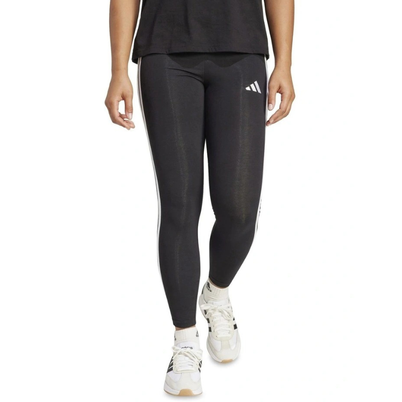 Person wearing black Adidas leggings with white stripes on a white background