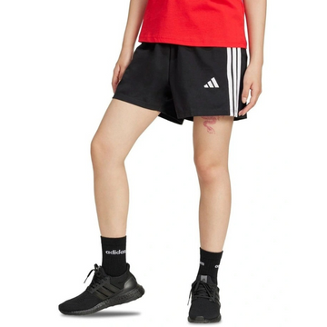 Person wearing black Adidas shorts and shoes on a white background