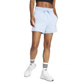 Person wearing light blue shorts and white sneakers on a white background