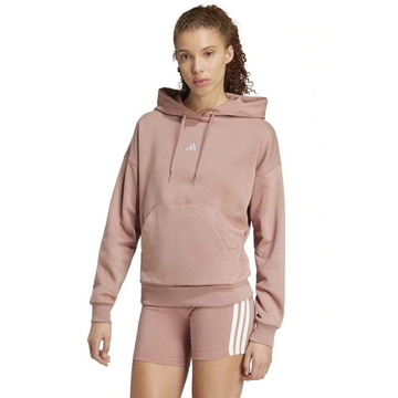 Woman wearing a pink Adidas hoodie and shorts on a white background