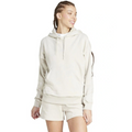 Woman wearing a beige hoodie and shorts on a white background