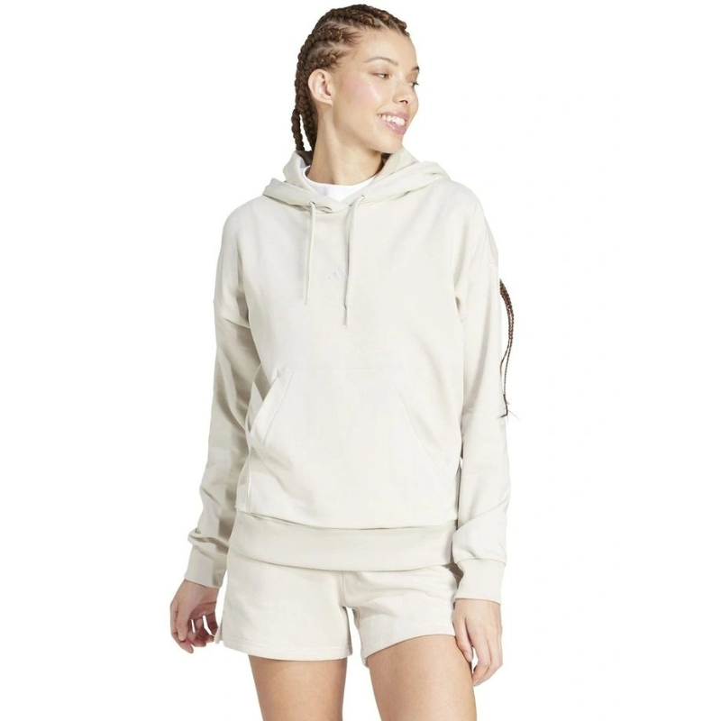 Woman wearing a beige hoodie and shorts on a white background