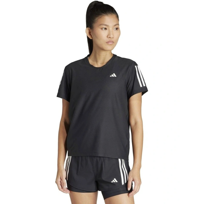 Woman wearing a black Adidas athletic outfit on a white background