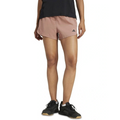 Person wearing pink Adidas shorts on a white background