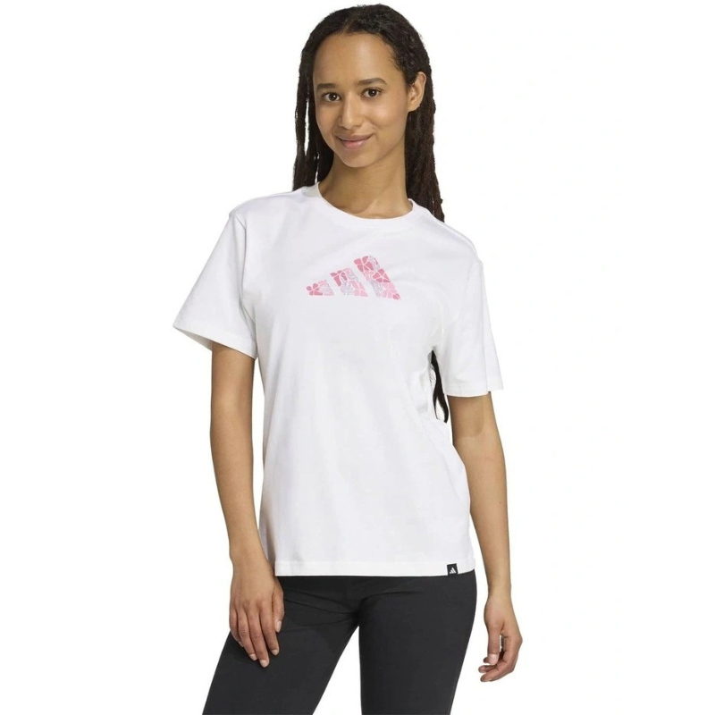 Person wearing a white t-shirt with pink graphics on a white background