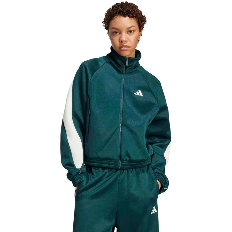Person wearing a green Adidas tracksuit on a white background