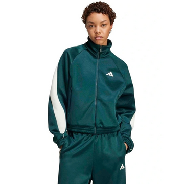 Person wearing a green Adidas tracksuit on a white background
