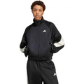 Person wearing a black Adidas tracksuit on a white background