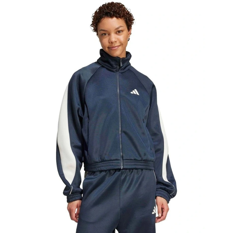 Person wearing a navy tracksuit with white sleeves on a white background