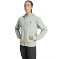 Woman wearing a light gray Adidas hoodie on a white background