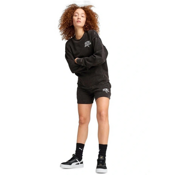 Person wearing a black hoodie and shorts set with visible branding on a white background
