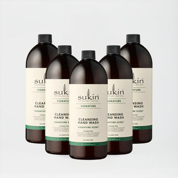 Five bottles of Sukin hand wash on a light gray background