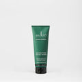 Green tube of Sukin Super Greens Detoxifying Facial Scrub on a white background