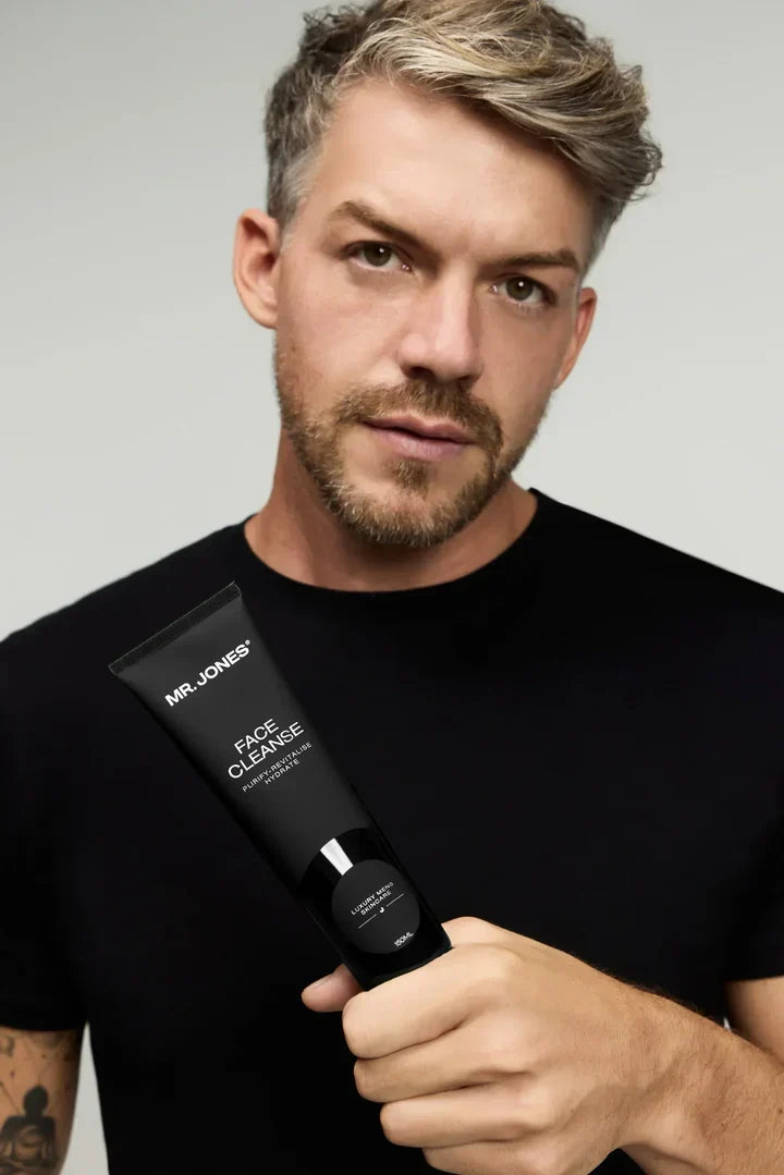Virtue men’s skincare set with cleanser, exfoliator, moisturizer, face mask, and serum in sleek black packaging displayed with male models