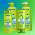 Garnier Fructis shampoo and conditioner bottles on a gradient blue to green background
