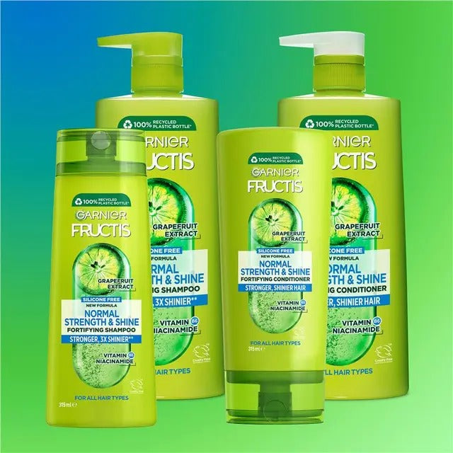 Garnier Fructis shampoo and conditioner bottles on a gradient blue to green background