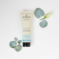 Sukin hair mask tube with eucalyptus leaves on a white background
