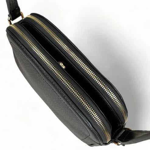Premium black leather crossbody shoulder bag with adjustable strap, sleek minimalist design, and high-quality stitching for everyday use.