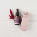 Sukin Intensive Firming Serum with packaging on a textured white surface