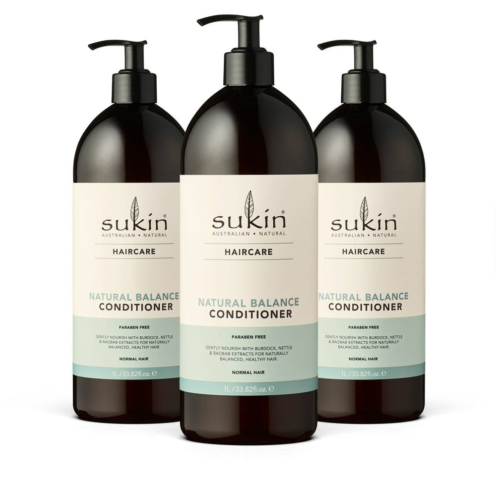 Three bottles of Sukin Natural Balance Conditioner on a white background