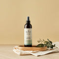Sukin hair care product on a wooden tray with a beige background