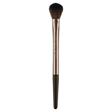 Makeup brush with rose gold handle and black bristles on a white background