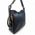 Black genuine leather tote bag with premium craftsmanship, minimalist design, and spacious interior from LeatherLuxe.