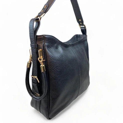 Black genuine leather tote bag with premium craftsmanship, minimalist design, and spacious interior from LeatherLuxe.