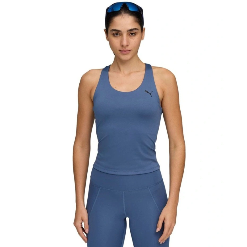 Woman wearing a blue athletic outfit with a Puma logo on a white background