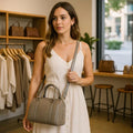 Beige genuine leather barrel shoulder bag with adjustable strap, minimalist design, and premium handcrafted finish.