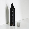 Black hair mousse bottle labeled 'Silhouette' on a white background