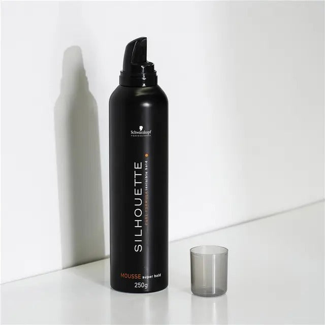 Black hair mousse bottle labeled 'Silhouette' on a white background