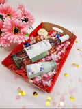 Purple Lavvish self-care gift box with skincare products, bath salts, soap bar, facial roller, and bath bomb displayed on purple floral background