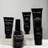 Virtue men’s skincare set with cleanser, exfoliator, moisturizer, face mask, and serum in sleek black packaging displayed with male models