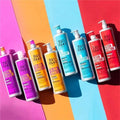 Collection of Bed Head hair care products on a colorful background