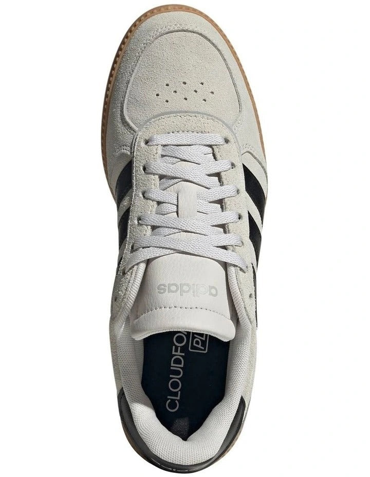 White Adidas sneaker with black stripes on a white background