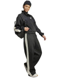 Adidas Stadium Stripes Tracksuit Bottoms in black with signature 3-Stripes, soft recycled polyester-cotton blend, satin piping, and matte rubber-print logo.